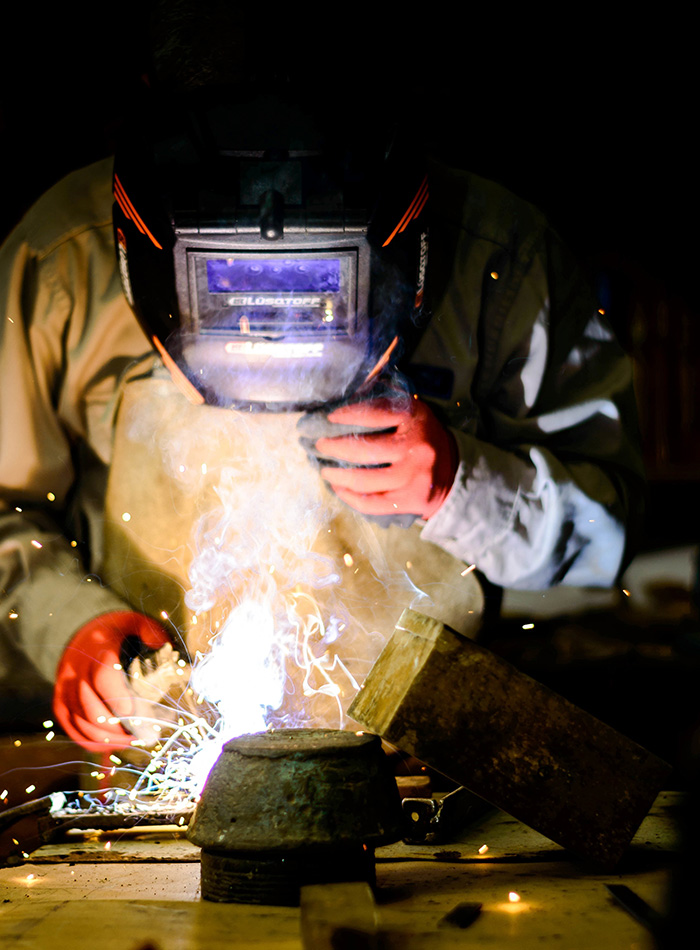 unrecognizable person wearing a helmet and welding GT22LPJ